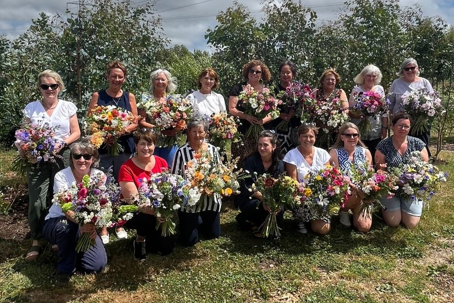 particpants in the Organic Blooms hand tied bouquet workshop, holding their bouquets